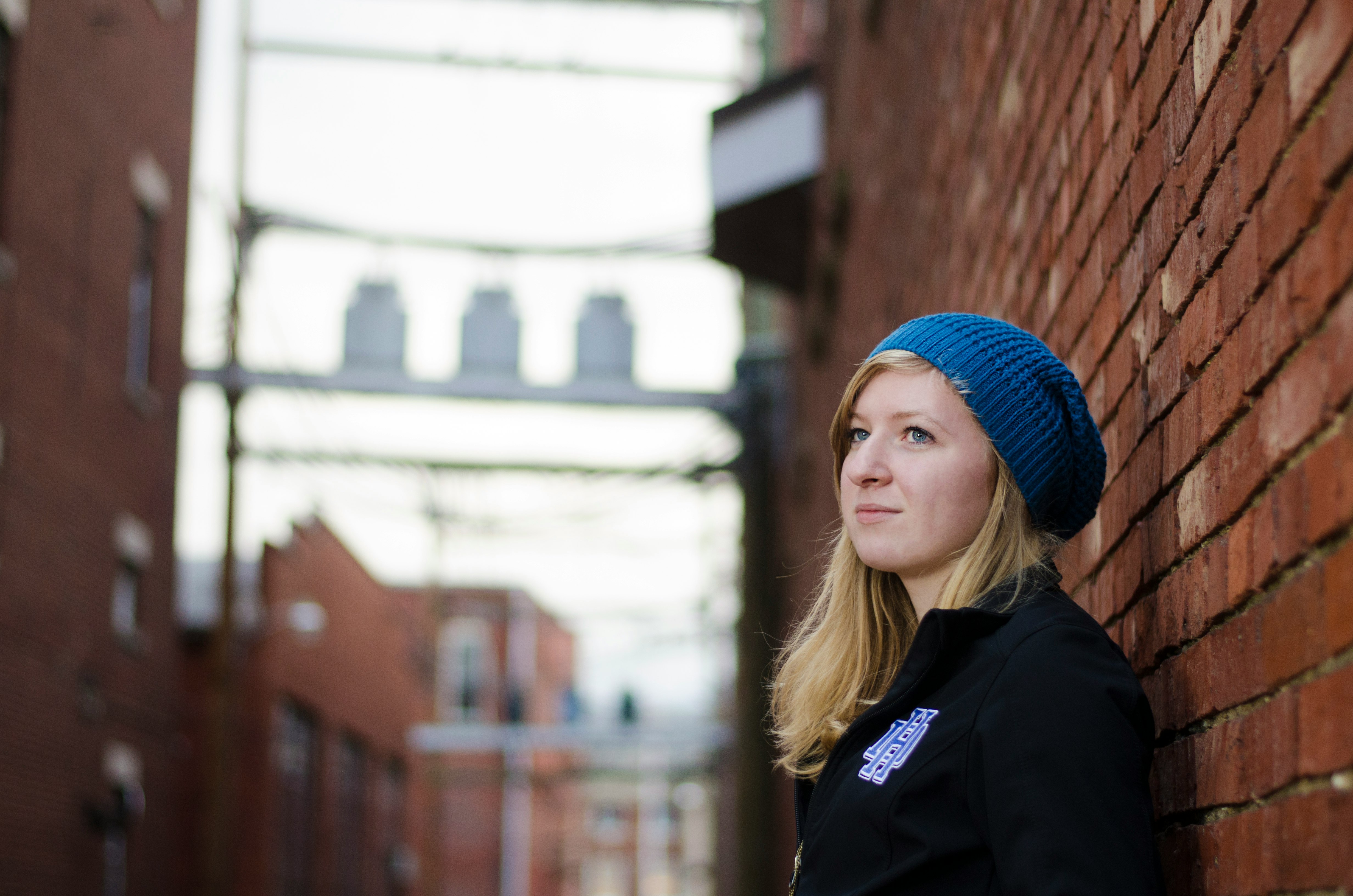 woman in blue knit cap and black jacket